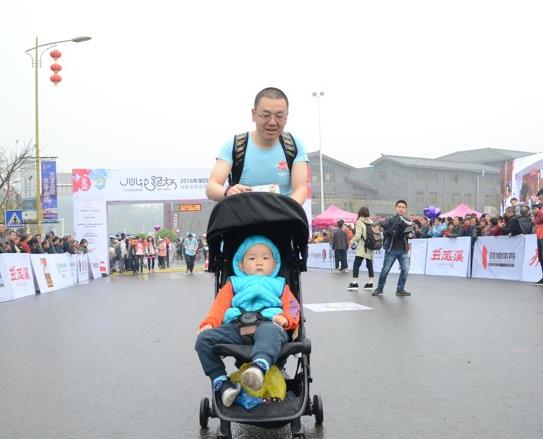超级奶爸现身金堂马拉松赛场 推婴儿车带娃跑步